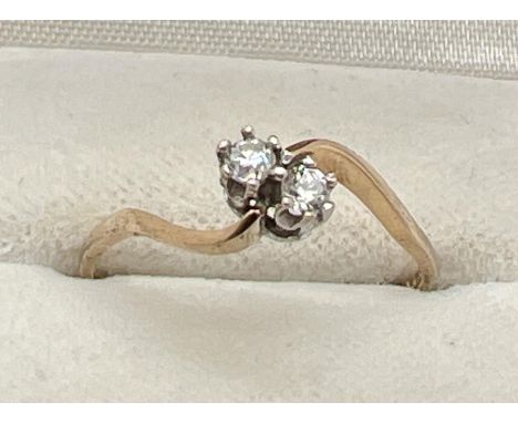 A vintage 9ct gold double diamond twist design dress ring. Two single 0.07 carat diamonds in a vertical side by side mount. F