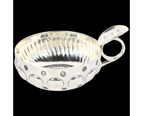 A French silver wine taster, with relief embossed decoration, indistinct maker's mark, bowl diameter 8cm, 3.5ozNo damage or r