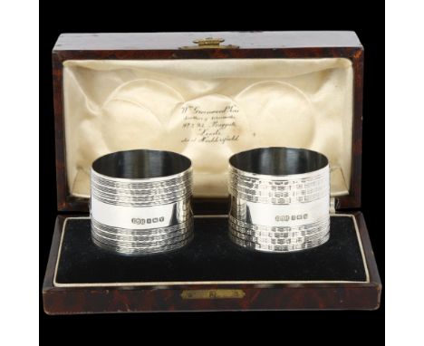 A pair of George VI silver napkin rings, Edwin Joseph Houlston, Birmingham 1945, cylindrical form with engine turned wavy dec