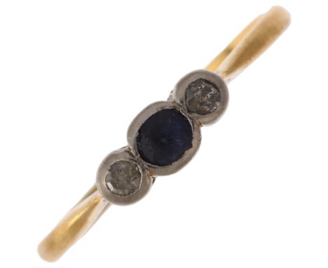 An early 20th century 18ct gold three stone sapphire and diamond ring, total diamond content approx 0.1ct, setting height 4mm