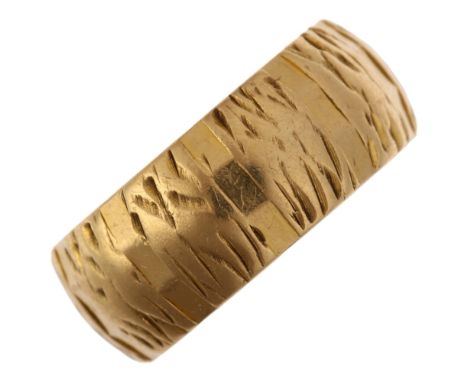 A late 20th century 18ct gold wedding band ring, maker J Ltd, London 1970, textured decoration, band width 7.7mm, size N, 6.7