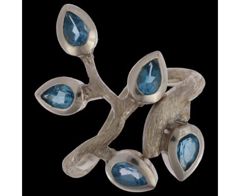 A large sterling silver blue topaz naturalistic branch dress ring, rub-over set with pear-cut topaz and textured settings, se