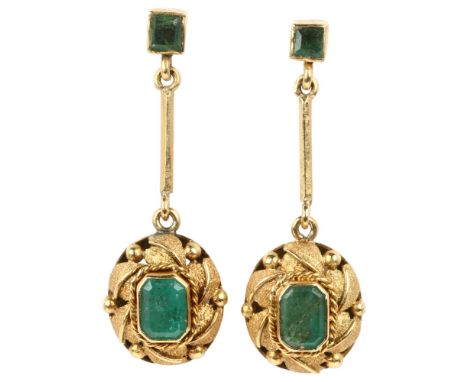 A pair of late 20th century emerald drop earrings, rub-over set with octagonal and square step-cut emeralds, with leaf decora