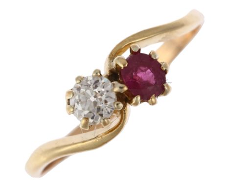 An early 20th century two stone ruby and diamond crossover ring, claw set with round-cut ruby and 0.25ct old European-cut dia