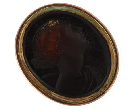 A 19th century glass intaglio seal ring, depicting Classical female profile, in unmarked gold mount, setting height 23.8mm, s