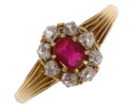 An early/mid 20th century ruby and diamond oval cluster ring, claw set with 0.35ct oval mixed-cut ruby surrounded by old-cut 