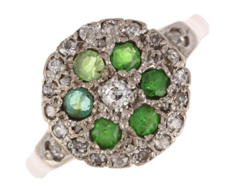 A late 20th century 18ct gold green stone, demantoid garnet and diamond circular cluster ring, maker JM Co, London 1984, pave