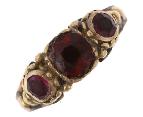 An early 20th century three stone garnet half hoop ring, apparently unmarked, setting height 6mm, size K, 2.2gHead of ring ha
