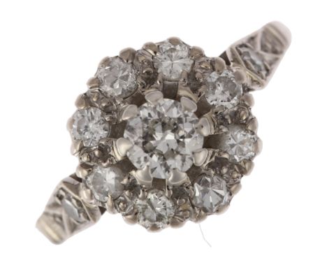 An 18ct white gold diamond flowerhead cluster ring, claw set with round-cut diamonds, total diamond content approx 0.75ct, se