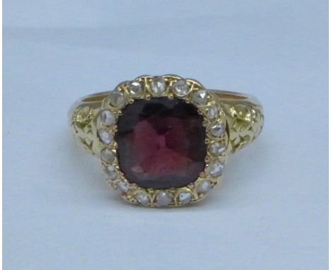 An Edwardian 18ct gold, diamond and garnet ring, Birmingham 1902, garnet approximately 2 carat, 5.5g, K, with a copy of a 200