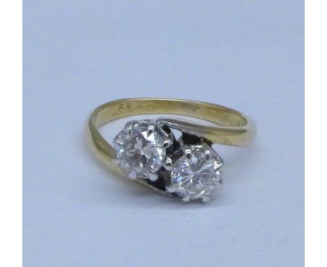 An 18ct gold, two diamond crossover ring, approximately one carat total diamond weight, 3.4g, K