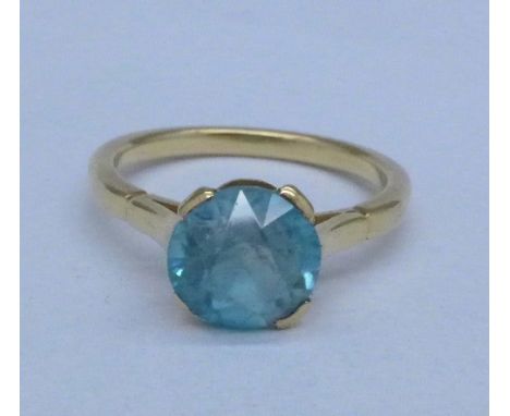 A yellow metal and pale blue stone ring, 3.2g, K