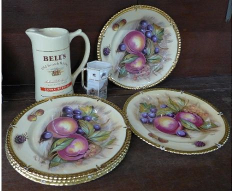 A collection of five Aynsley fruit pattern and gilt edged plates, signed D. Jones, a Bell's Old Scotch Whisky jug and a Point