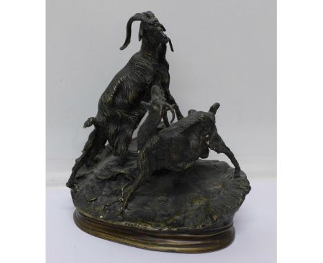 A bronze model of two goats, signed