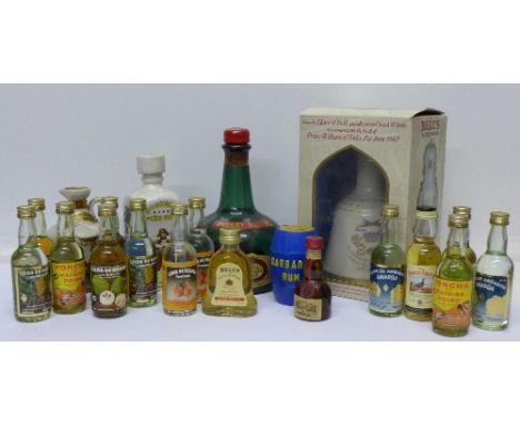 A Bell's Scotch Whisky decanter, boxed, a Cherry Bestle bottle (empty) with musical movement and eighteen miniature spirit bo