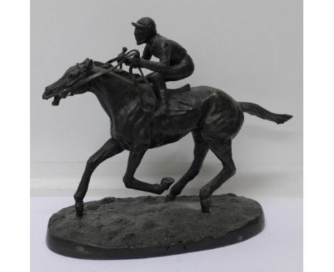 A bronze model of a horse and jockey, signed