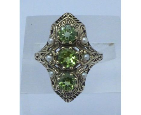 A 9ct gold, peridot and seed pearl ring, 3.9g, O