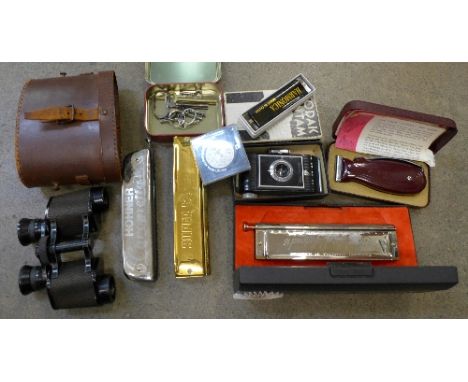 A Hohner Larry Adler Professional harmonica, three other harmonicas, a Kodak Bantam camera, a Viceroy dry shaver, a pair of O