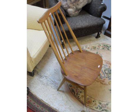 A set of four Ercol elm stick back dining chairs