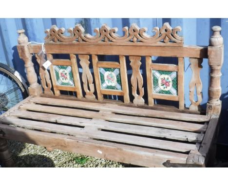 An Eastern hardwood bench with tile back slatted seat on turned supports