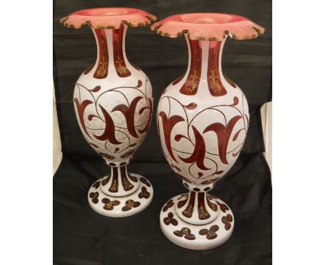 A pair of Victorian ruby glass vases with white enamel overlaid and gilt decoration CONDITION REPORTS Both vases stand at app