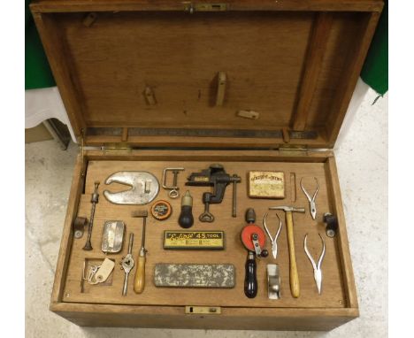 A circa 1900 teak and brass bound trunk, later fitted as a tool chest, together with various tools in fitted trays