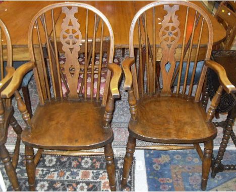 A set of six beech and elm wheel and stick back elbow chairs by "T. W." (stamped to rear of seats) together with a small carv