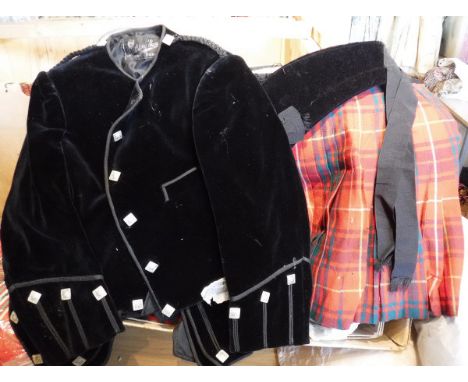A child's kilt and velvet jacket, together with two waistcoats, a pair of tartan shorts, sash, two hats and a sporran in the 