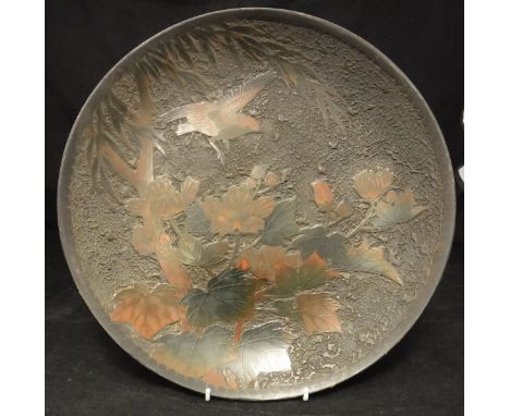 A 19th Century Japanese cloisonne on porcelain charger depicting a bird amongst blossoming foliage, bearing four character ma