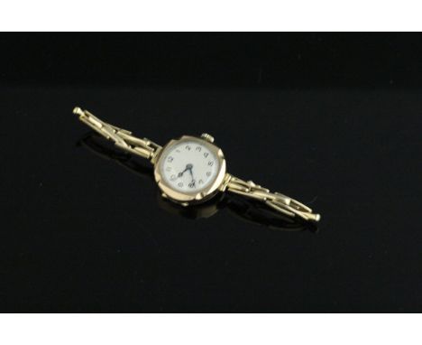 A ladies 9 carat gold wrist watch, the white enamel dial set with Arabic numerals