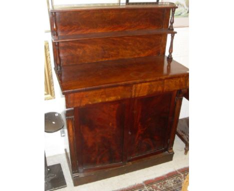 A 19th Century mahogany chiffonier with three-quarter brass gallery top shelf on baluster turned supports above two drawers a