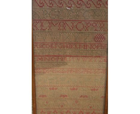 A late 18th Century sampler by Peggy Shaw dated 1783 worked with alphabet and floral sprays 