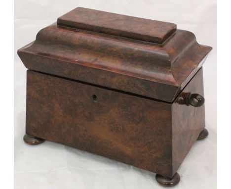 A 19th Century burr yew veneered tea caddy of sarcophagus form raised on squat bun feet