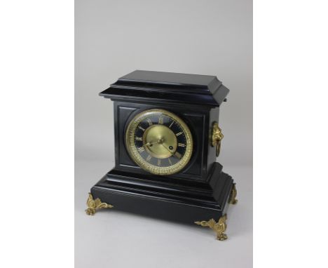 A Victorian slate mantel clock with black chapter ring and gilt Roman numerals and bezel, in rectangular case with stepped ba