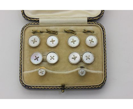 A cased set of dress cufflinks, four buttons and a pair of studs, the mother of pearl buttons in 18ct and 9ct gold