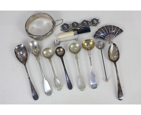 A collection of Victorian and later silver tea and condiment spoons, a silver mounted cigarette holder, a Niello brooch and b