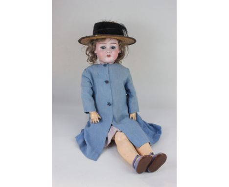 A Max Handwerck bisque head doll with brown wig, sleeping blue eyes and open mouth revealing four teeth, marked Max Handwerck