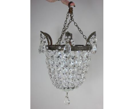 A hanging light pendant with cut glass droplet
