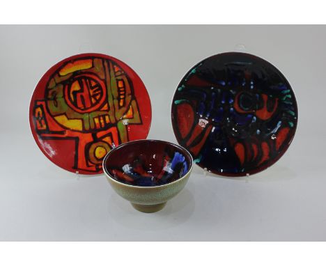 Two pieces of Poole Potter Delphis by Carol Cutler, the bowl in red and blue, the dish in abstract red and orange, together w