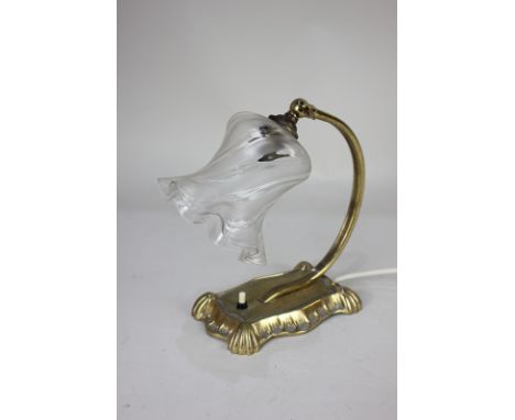 An early 20th century brass lady's desk lamp with frilled glass shade
