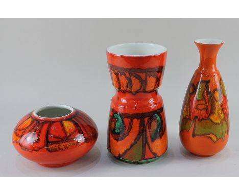 Three Poole Pottery Delphis vases, all with abstract designs on red ground, tallest 24cm high