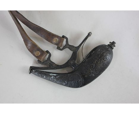 An Indian cast bronze gunpowder flask with leather belt strap