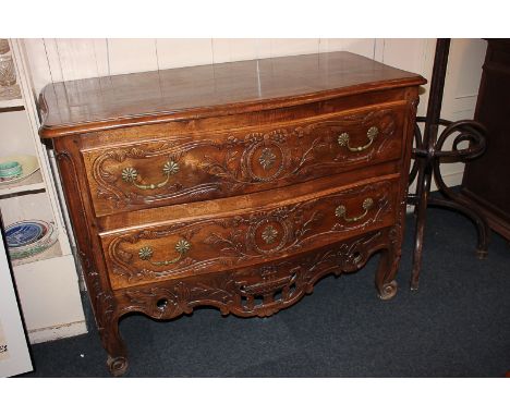 A French style commode with two floral decorated bow front drawers, pierced apron, on foliate and scroll legs, 125cm