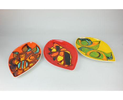 Three Poole Pottery Delphis leaf shaped dishes, one by Gillian Taylor, the geometric designs on yellow, orange and red ground