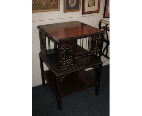 An Edwardian revolving bookstand with square swivel top, on base with shelf and fretwork panels in the Chinese Chippendale st