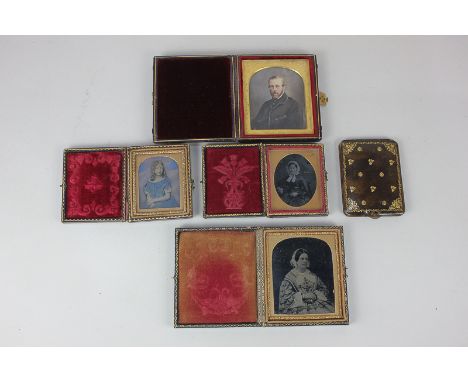 Three Victorian daguerreotypes of two women and a child, and a miniature portrait of a gentleman, each in leather case, toget