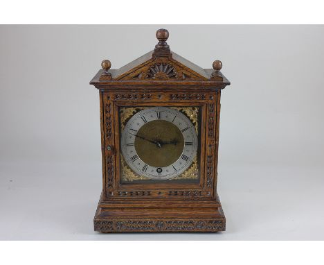 *An oak cased mantel clock, the brass dial with silvered chapter ring and Roman numerals, the movement stamped 'W &amp; H Sch