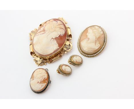A large shell cameo brooch in gold mount, a shell cameo brooch with seed pearl border, and a pair of cameo ear clips