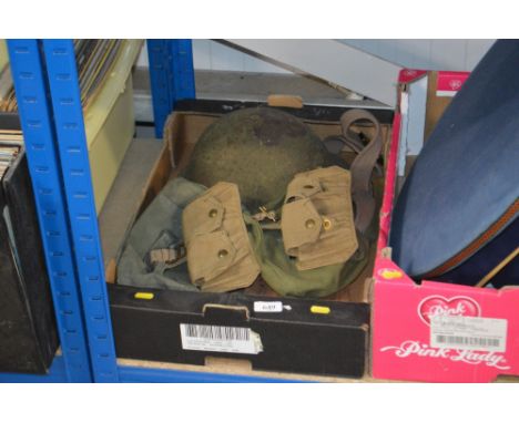 A box containing various military webbing; tin helmet etc.
