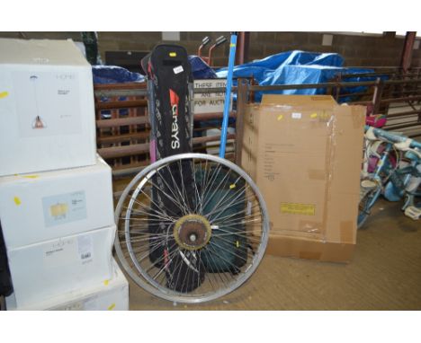 A quantity of hockey sticks; two bike rims; and a pogo stick etc. 